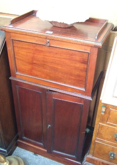 Appraisal: A mahogany music cabinet with gallery top a fall front