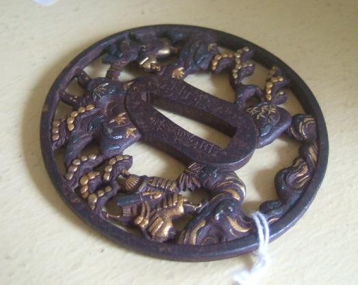 Appraisal: An iron tsuba th century of circular form carved and