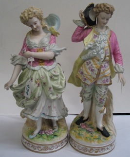 Appraisal: PAIR OF GERMAN PAINTED PORCELAIN BISQUE FIGURES hand painted of