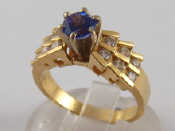 Appraisal: A yellow metal tests carat gold tanzanite and diamond ring