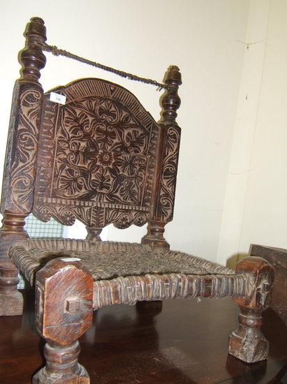 Appraisal: An Eastern low carved wooden chair possibly from Afghanistan wide