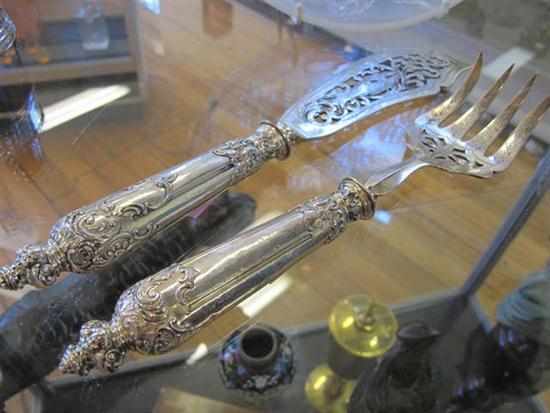 Appraisal: PAIR OF TH CENTURY CONTINENTAL SILVER CHERUB DECORATED HANDLE FISH