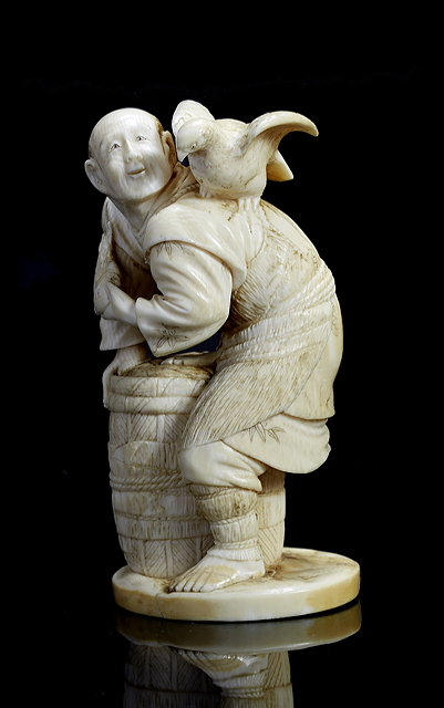 Appraisal: A Japanese ivory okimonoMeiji period - a fisherman standing over