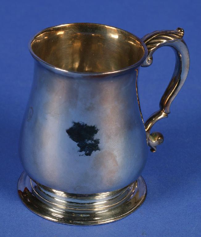 Appraisal: A GEORGE II MUG of baluster form with a leaf-capped