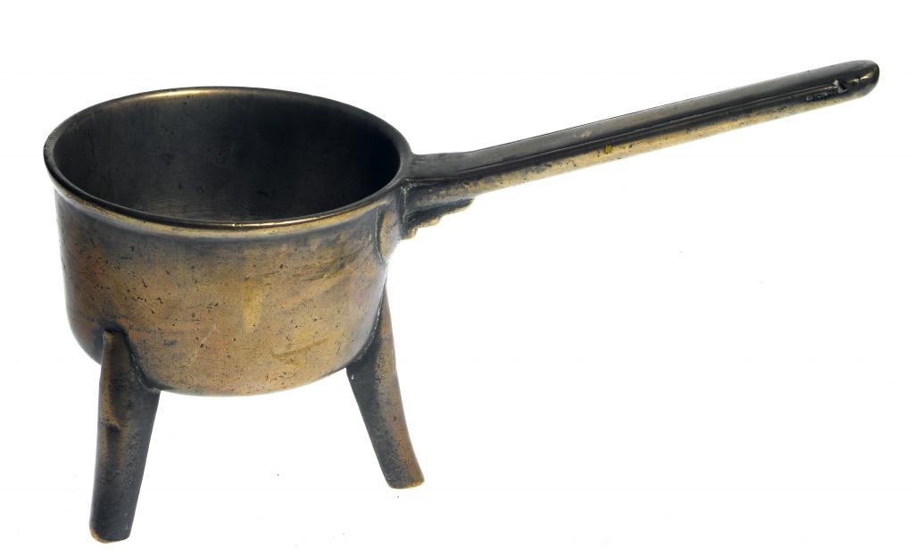 Appraisal: AN ENGLISH LEAD-BRONZE SKILLET the cast handle moulded with two