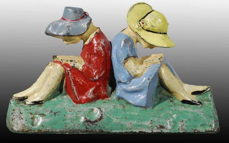 Appraisal: Cast Iron Girls Reading Doorstop Description Depicts two girls reading