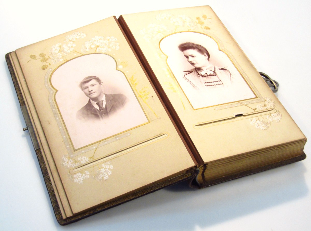 Appraisal: A Victorian photograph album with pressed leather black boards raised