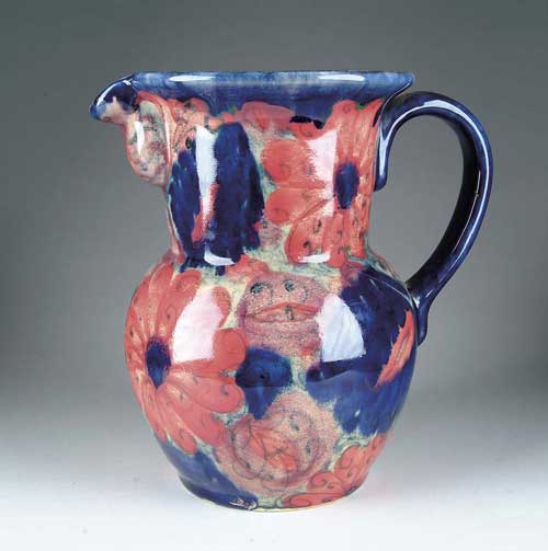 Appraisal: MOORCROFT ART POTTERY PITCHER Bulbous pitcher has bright flower decorations