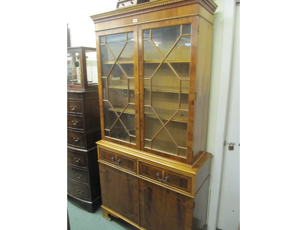 Appraisal: Reproduction yew wood bookcase on cupboard base