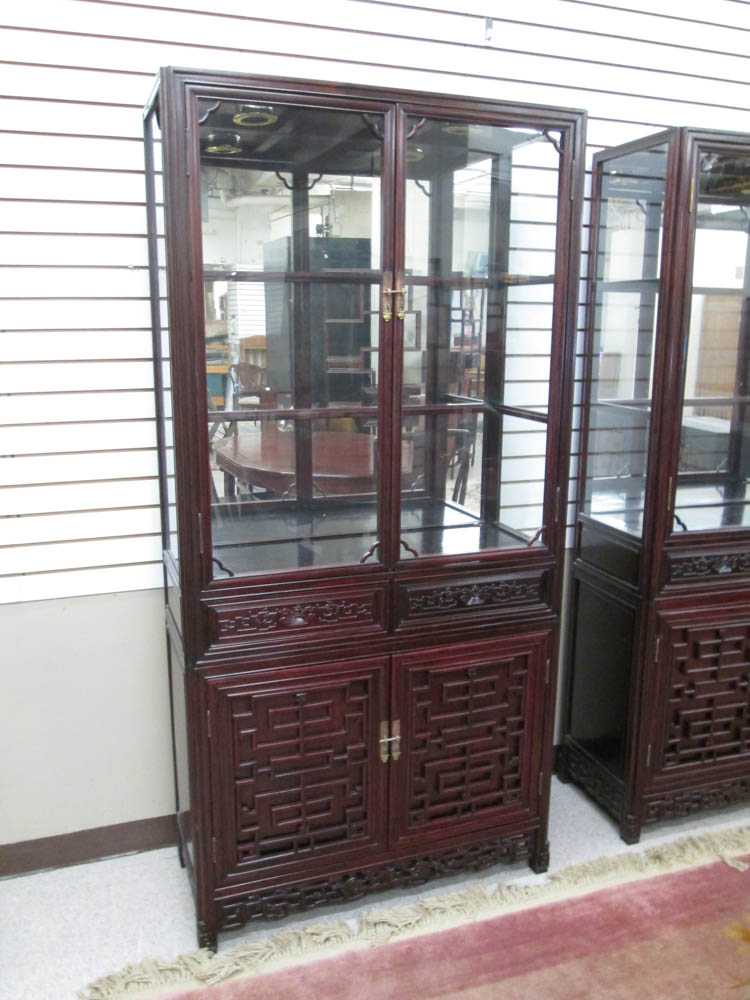 Appraisal: CHINESE ROSEWOOD DISPLAY CABINET ON CABINET the upper cabinet fitted