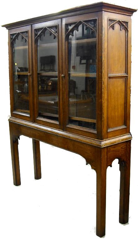 Appraisal: Gothic oak bookcase the moulded cornice over a glazed panel