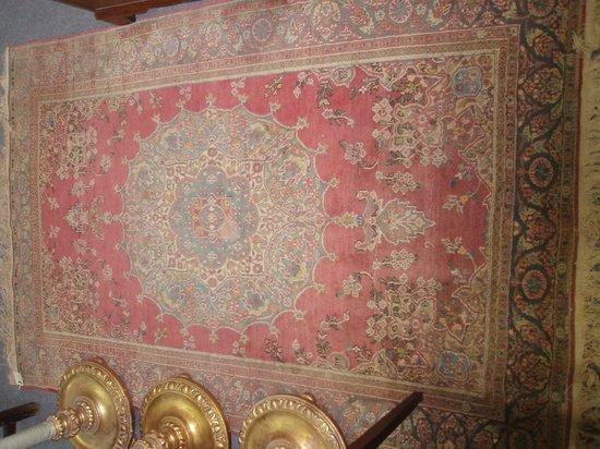 Appraisal: A bordered and figured Kashmir rug of crimson ground with