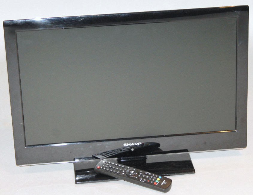 Appraisal: A Sharp colour television in black trim with remote control