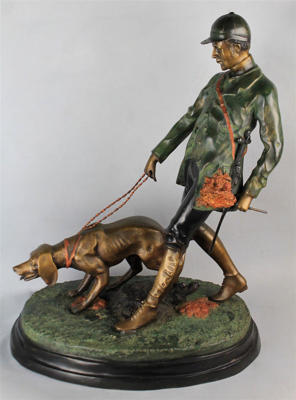 Appraisal: A PAINTED METAL GROUP OF A HUNTER AND DOG h