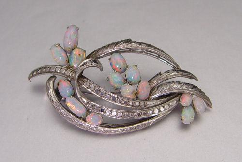 Appraisal: K OPAL BROOCH K white gold brooch contains fourteen oval