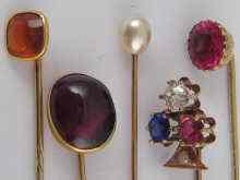 Appraisal: A mixed lot comprising five stick pins including one set