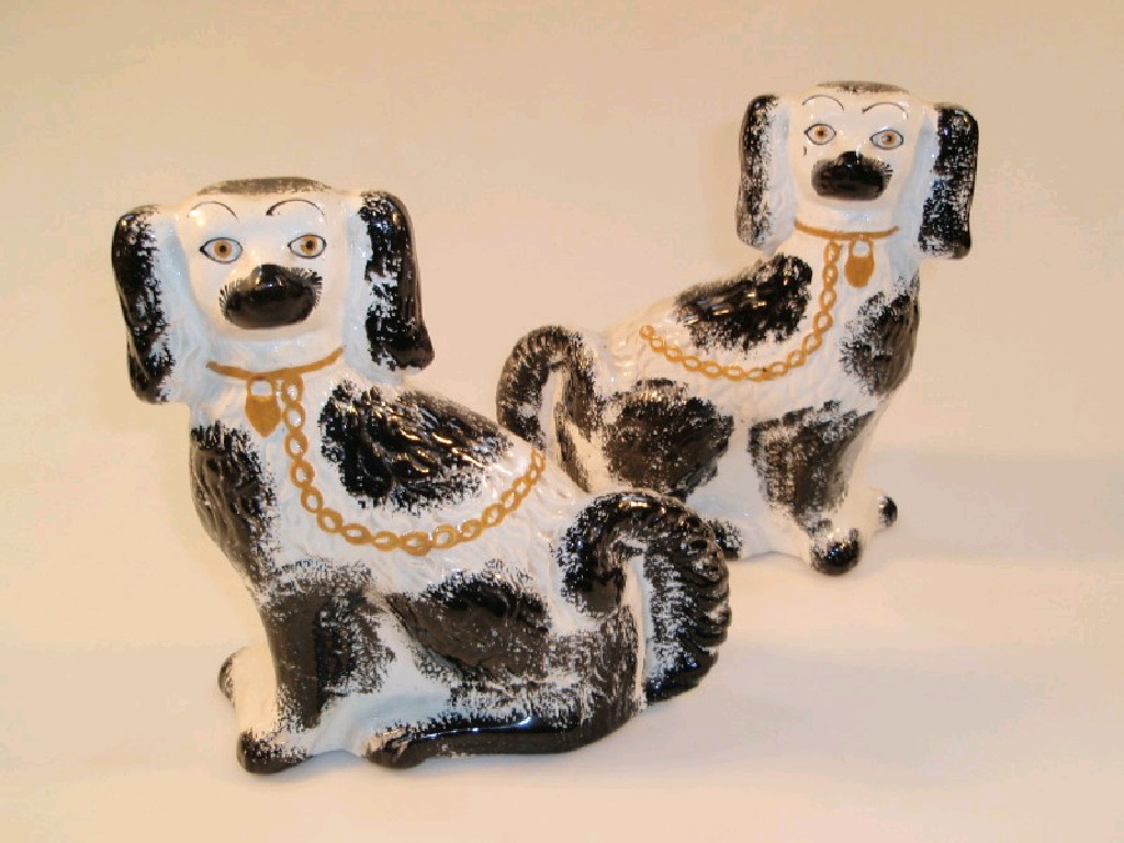 Appraisal: A pair of Victorian Staffordshire King Charles Spaniel comforter dogs