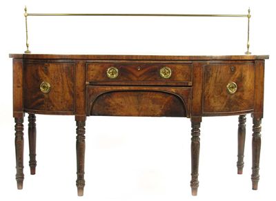 Appraisal: A Regency mahogany barrel front sideboard with turned brass curtain