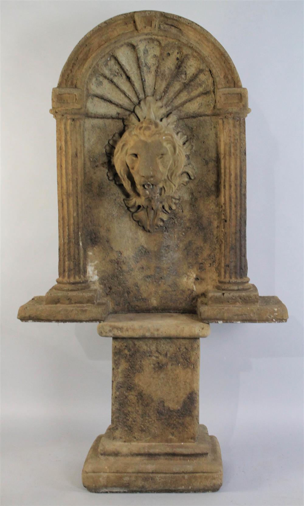 Appraisal: LION HEAD STONE FOUNTAIN having a Palladian arch with scalloped