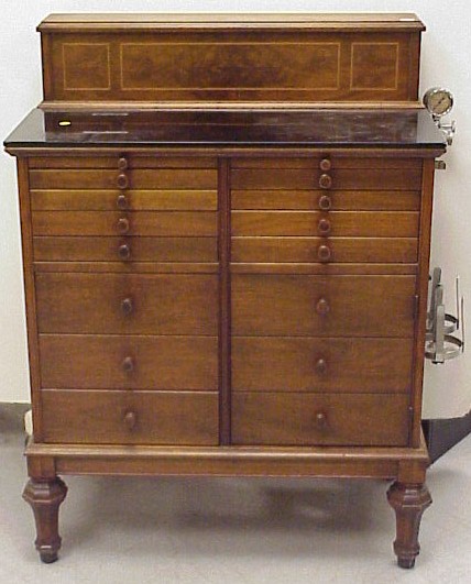 Appraisal: Dental cabinet walnut and walnut veneer with black glass fitted