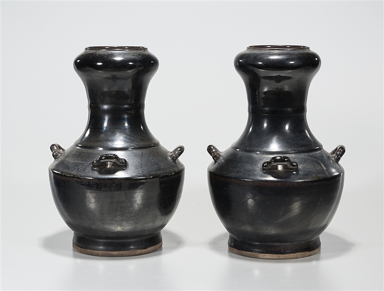 Appraisal: Pair of Chinese black glazed porcelain 'rotating vases four handles