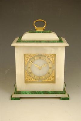 Appraisal: An onyx and malachite mantel clock with a platform escapement