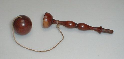 Appraisal: A Victorian Lignum Vitae Bilboquet with a baluster turned stem