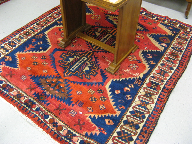 Appraisal: SIGNED PERSIAN TRIBAL AREA RUG hand knotted in a three