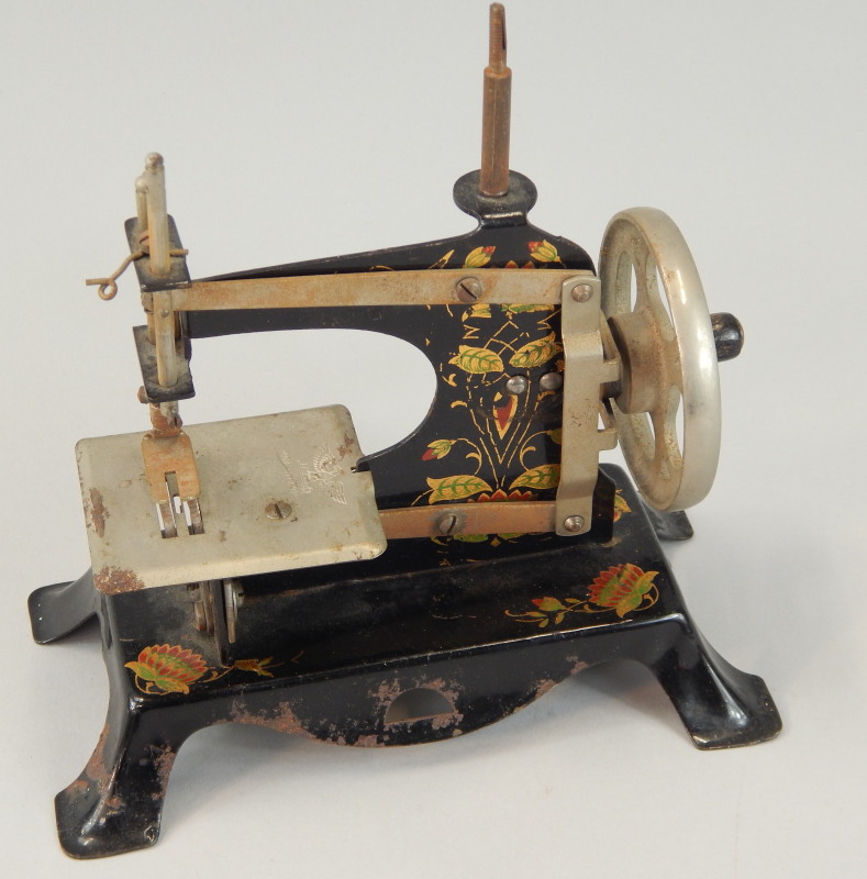 Appraisal: A German tin plate child's sewing machine stamped with an