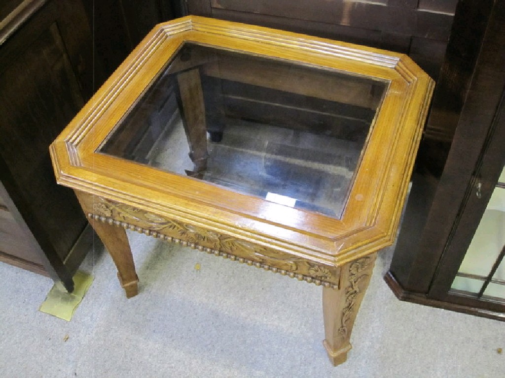 Appraisal: Carved oak occasional table with glass top