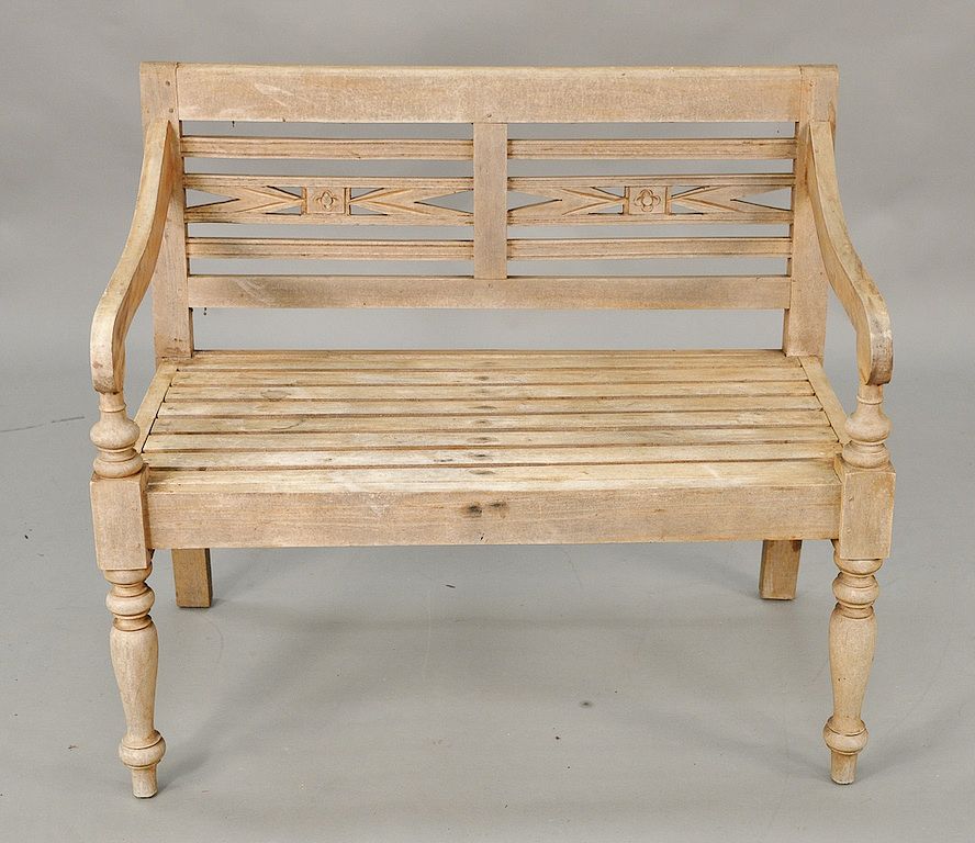 Appraisal: Teak outdoor bench with flower carvings set on turned legs