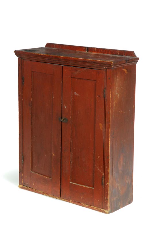 Appraisal: HANGING CUPBOARD Pennsylvania th century pine Original red paint Molded