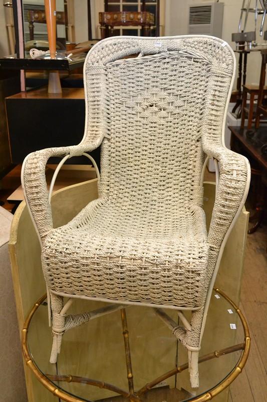 Appraisal: A WHITE WICKER CHAIR AND WHITE THREE PANEL SCREEN A