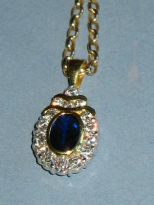 Appraisal: A SAPPHIRE AND DIAMOND PENDANT with oval sapphire mm long