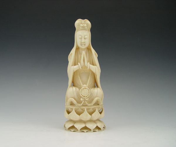 Appraisal: JAPANESE CARVED IVORY FEMALE ON LOTUS BLOSSOM Seated female with