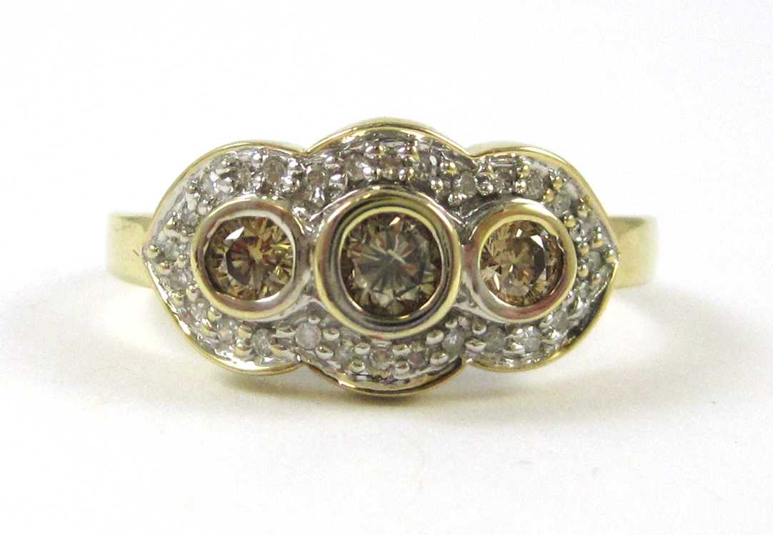 Appraisal: CHAMPAGNE DIAMOND AND TEN KARAT GOLD RING The yellow and