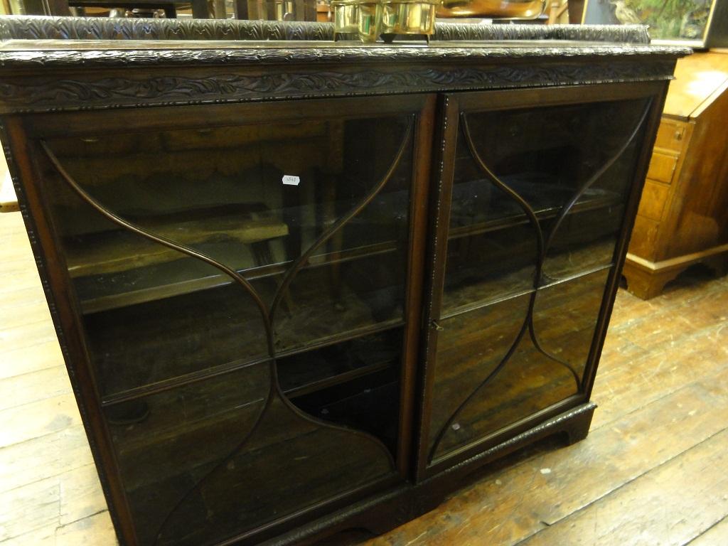 Appraisal: An Edwardian mahogany bookcase side cabinet enclosed by a pair