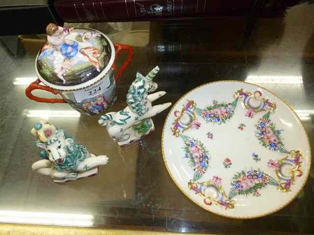 Appraisal: A CAPODIMONTE CHOCOLATE CUP COVER AND SAUCER decorated in relief