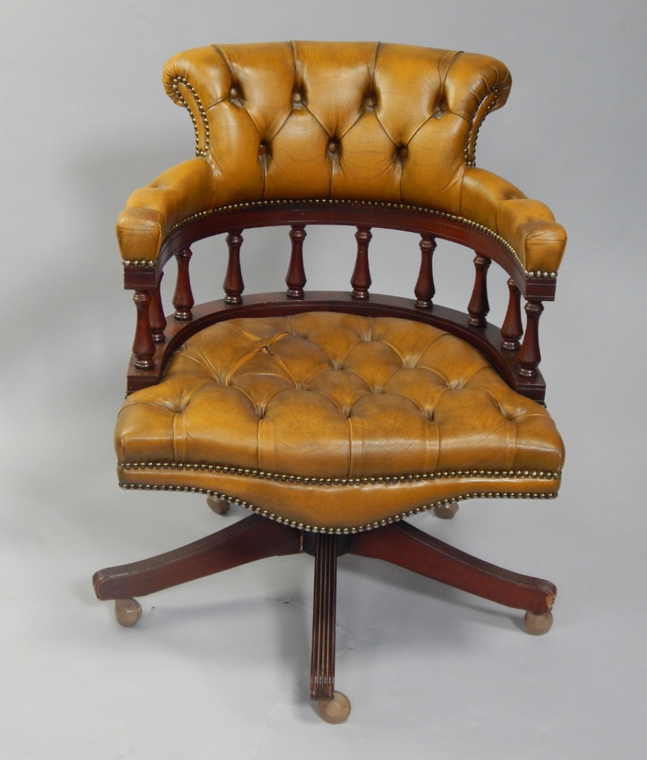 Appraisal: A leather seated button back captain's chair on five star