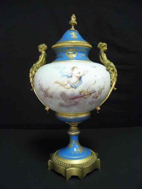 Appraisal: Porcelain hand painted covered urn with gilt metal mounts Blue