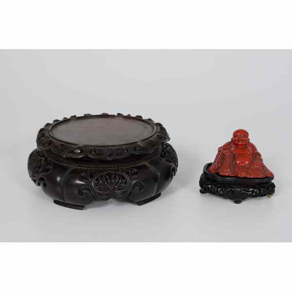 Appraisal: Chinese Buddha Plus Chinese A possibly resin Buddha seated on