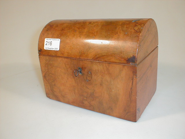 Appraisal: An antique walnut dome top tea caddy with fitted interior