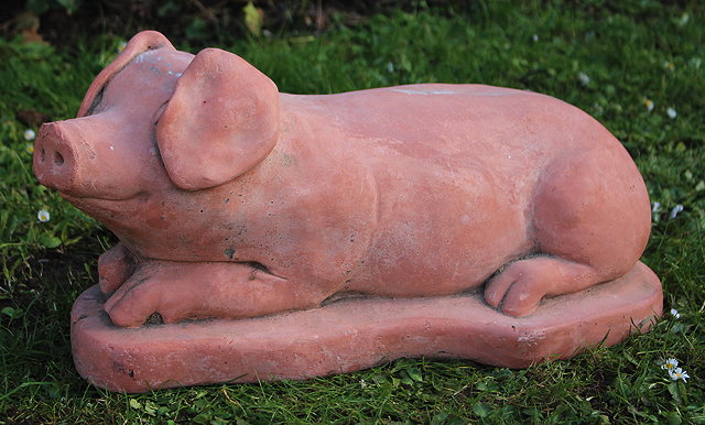 Appraisal: A RECUMBENT TERRACOTTA PIG cm long snout to tail