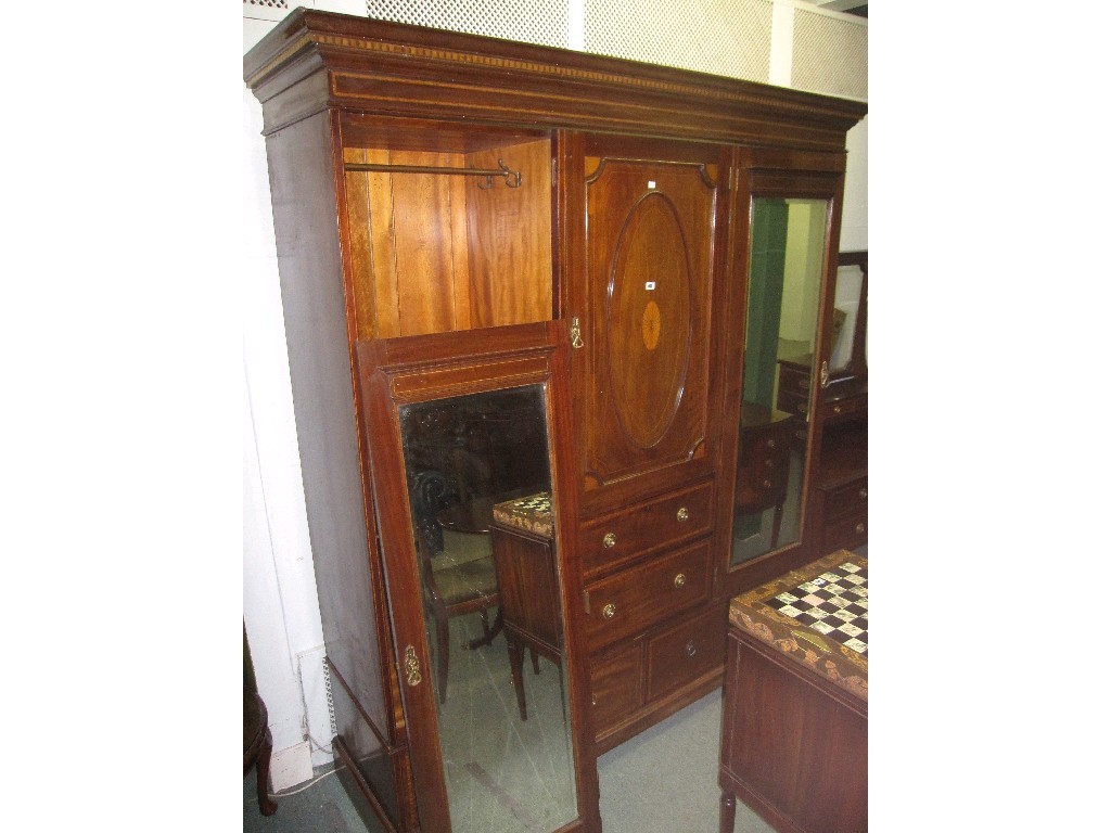 Appraisal: Edwardian mahogany and inlaid double mirrored door wardrobe the central