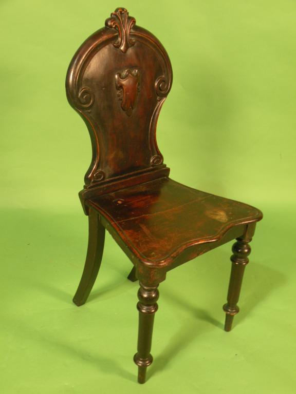 Appraisal: An early Victorian mahogany hall chair with a shield shaped