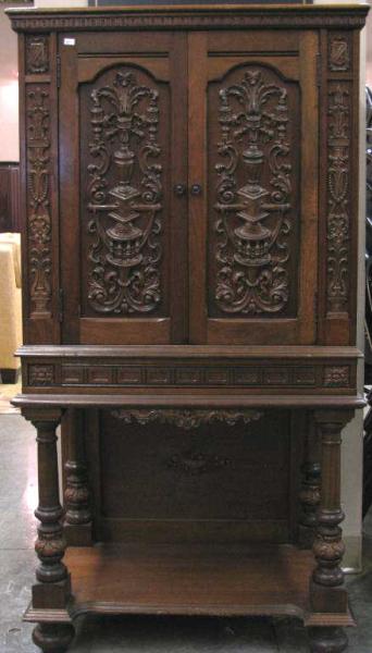 Appraisal: Vintage English Tudor-style walnut music cabinet with ornate applied carvings