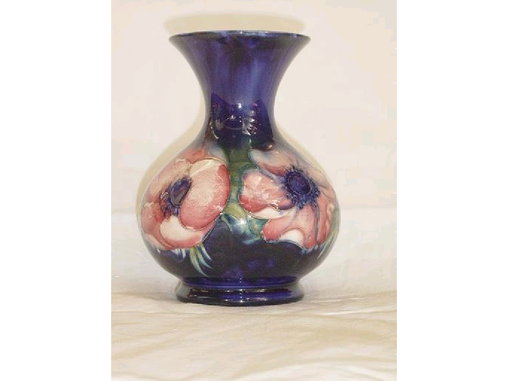 Appraisal: A blue ground Moorcroft vase with pink and mauve anemone