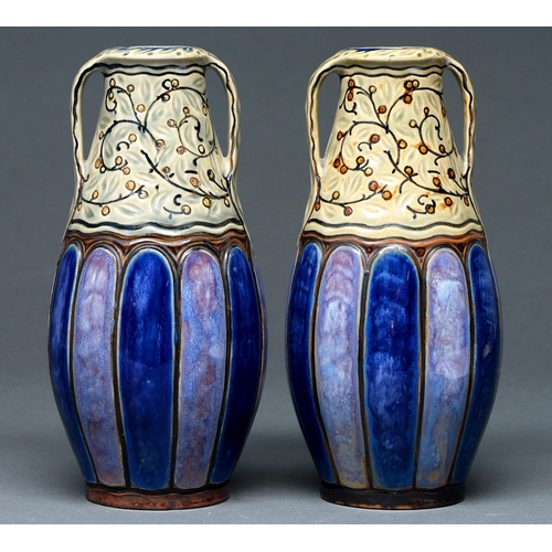 Appraisal: A pair of Doulton ware slip cast two handed vases