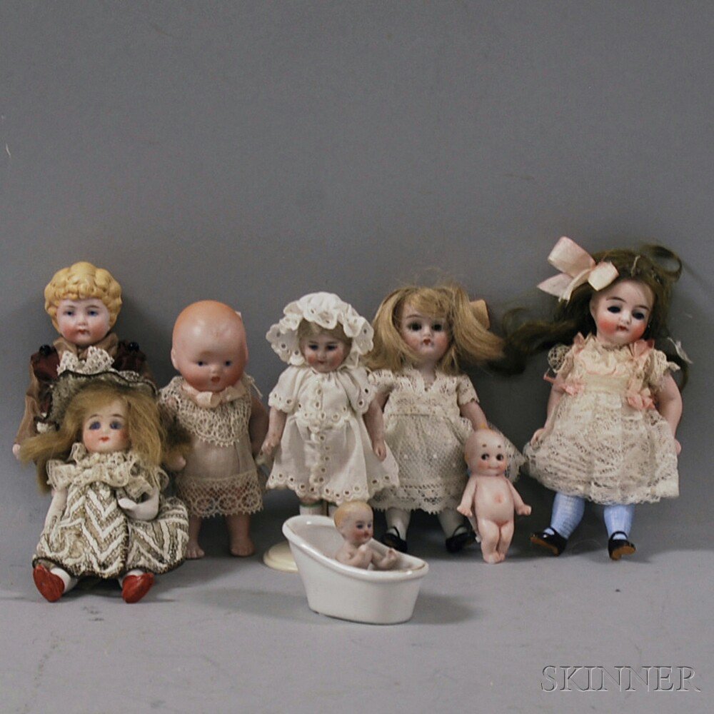 Appraisal: Eight Small All-bisque Dolls Germany tiny Kewpie-type seated baby in