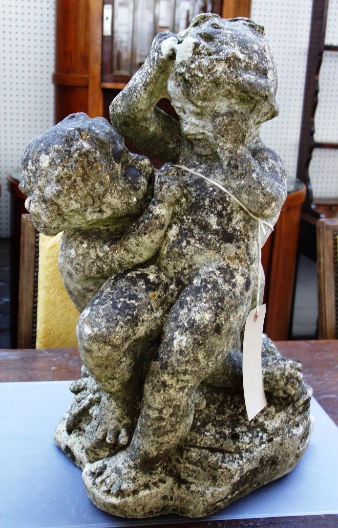 Appraisal: A reconstituted stone figure group of two cherubs cm wide